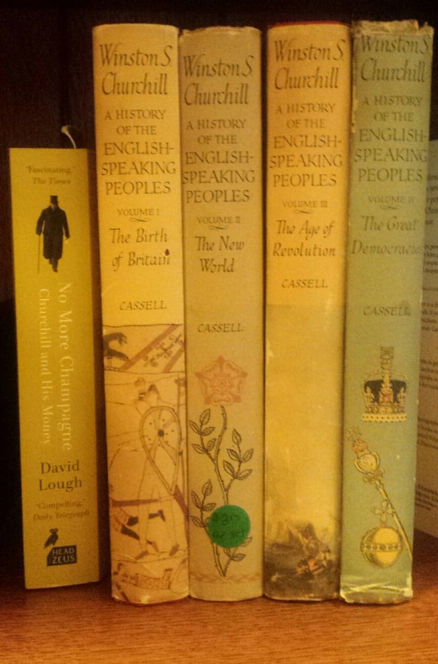 A collection of books by Winston S. Churchill on the history of English-speaking peoples, alongside a book titled "No More Champagne."