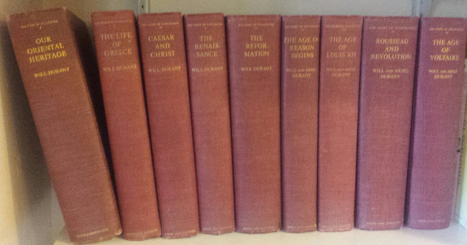 A row of classic, maroon-covered books by Will and Ariel Durant on a shelf.
