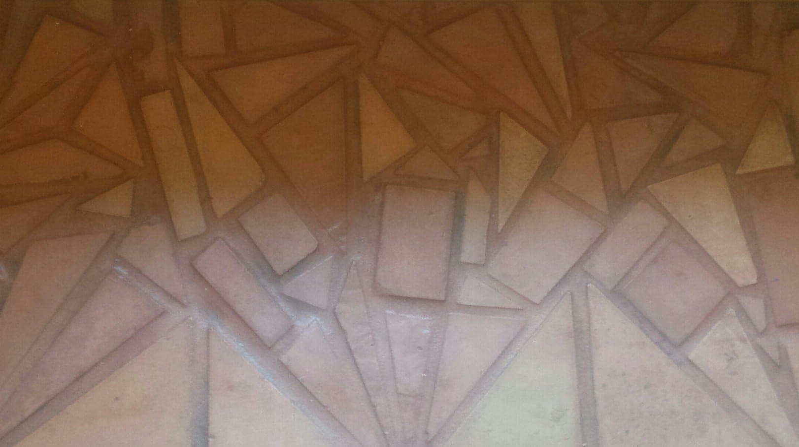 Abstract geometric pattern featuring triangular shapes in warm, earthy colors.